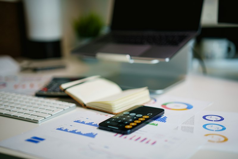 Close-up of calculator with financial documents and tax calculation spreadsheet
