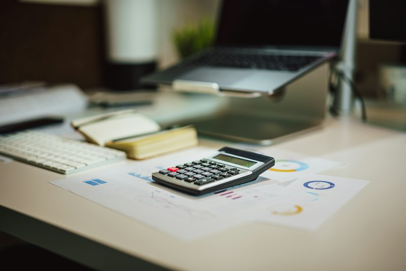 Tax planning documents, calculator, and financial paperwork organized on a workspace